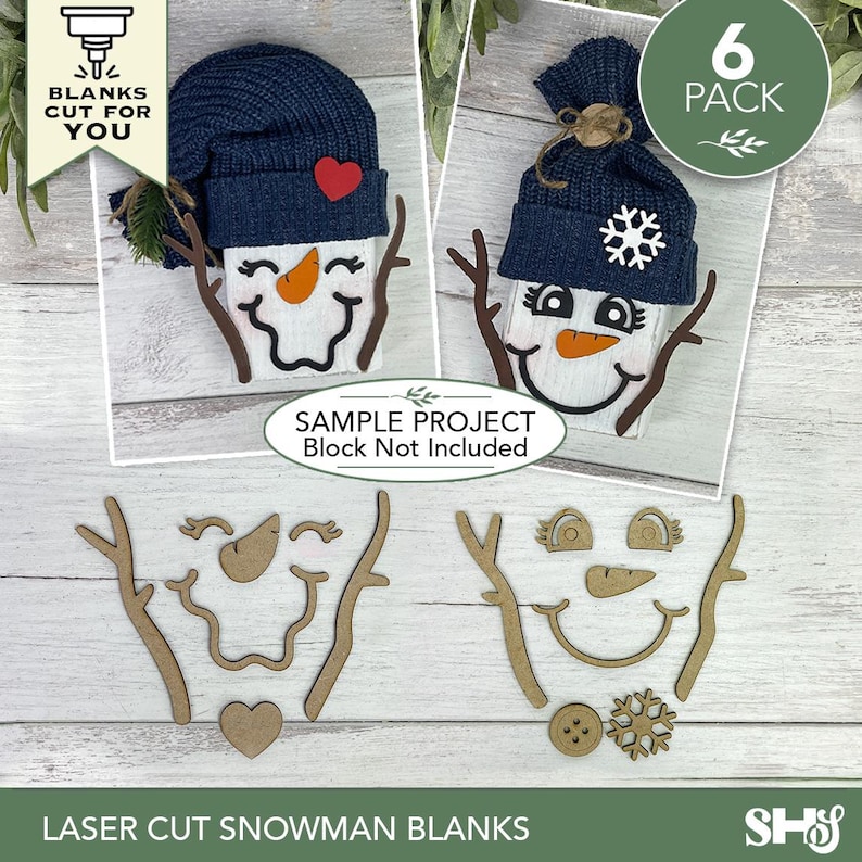 May include: A set of laser-cut wooden snowman face components including branch arms, carrot noses, eyes, mouths, hearts, buttons, and snowflake shapes. The kit includes pieces to create two distinct snowman designs, featuring dark blue knit hats.