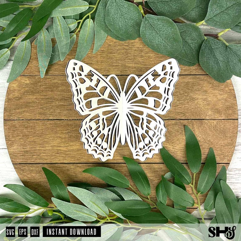 May include: A white laser-cut butterfly silhouette featuring intricate geometric wing patterns and symmetrical cutouts. The butterfly is centered and displays a clean, flat design with sharp edges, showcasing a detailed openwork structure.