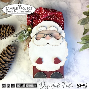May include: A Santa Claus figure crafted from wood and fabric, featuring a red hat with white stars, a white beard, and black glasses. The figure includes a small gold bell and green sprigs attached to the side. Text on the image reads: SAMPLE PROJECT Block Not Included. Digital File.