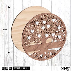 May include: A circular wooden tree of life wall art piece featuring a brown laser-cut design with eleven small white heart-shaped accents attached to the branches. A vertical arrow indicates a height of 12 inches for the circular wooden base.