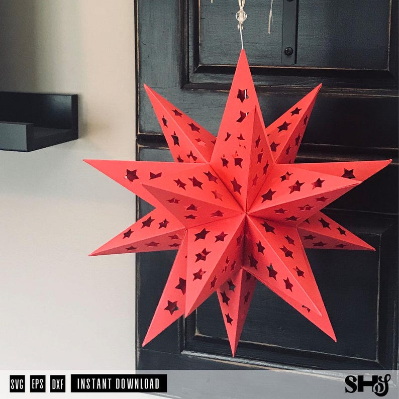 May include: A bright red, multi-pointed star lantern made of folded paper. The surface of the star features numerous small, die-cut star-shaped perforations throughout its structure, allowing light to pass through the geometric design.