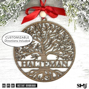 May include: A wooden tree of life ornament with the name "HATTEMAN" cut out in the centre. The ornament is brown with a red ribbon and a small wooden bead for hanging. Text on the ornament says "CUSTOMIZABLE Directions included".