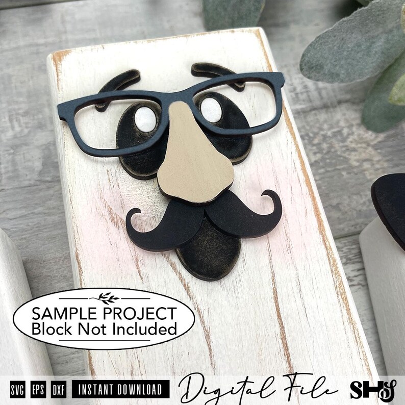 May include: A rectangular white wooden block featuring a layered cutout design of a face with black glasses, a tan nose, and a black mustache. An oval label on the block reads: SAMPLE PROJECT Block Not Included. Text at the bottom reads: Digital File.