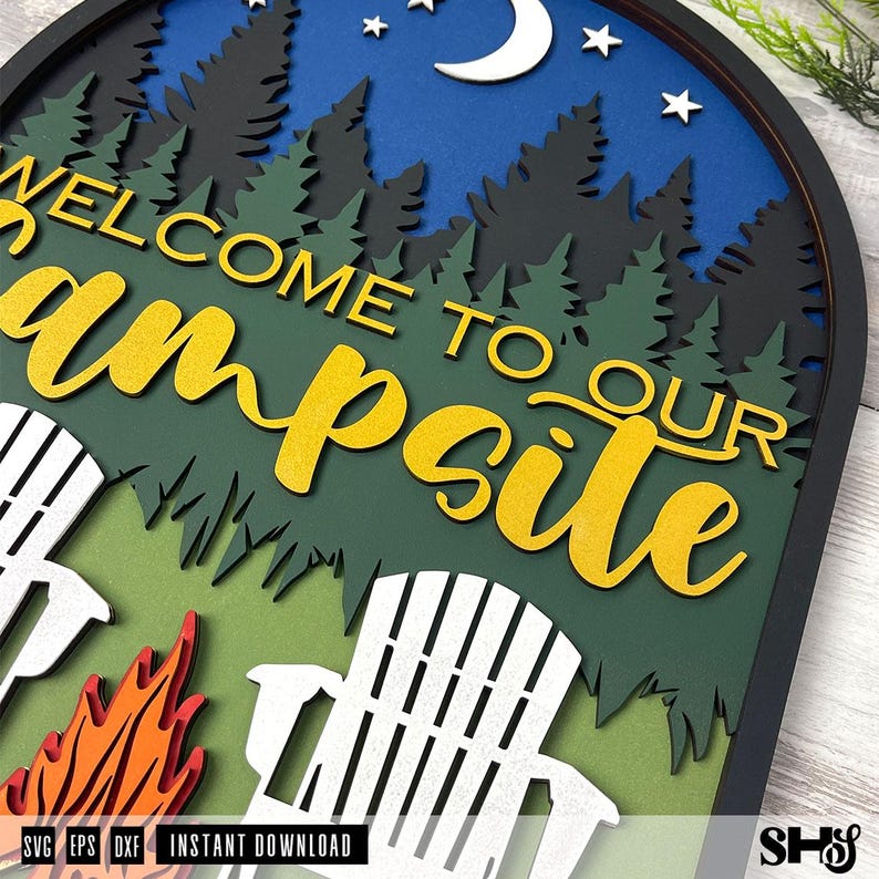 May include: A layered wooden wall sign with a dark frame featuring a night forest scene with a crescent moon and stars. The text reads WELCOME TO OUR campsite in yellow. The design includes two white chairs and a stylized orange campfire.
