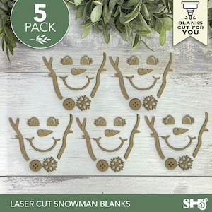 May include: A 5-pack of laser-cut wooden snowman face components, including eyes, carrot noses, curved mouths, stick arms, buttons, and snowflake shapes. These unfinished wood pieces are designed for crafting and holiday decoration projects.