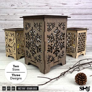 May include: Three wooden lanterns in varying shades of brown. The central lantern features a snowflake design, while the others showcase leaf and geometric patterns. The image includes text that says "Two Sizes" and "Three Designs".