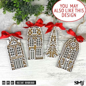 May include: Four laser-cut wooden ornaments featuring two house designs and one Christmas tree design, each layered with white intricate details and topped with a bright red satin ribbon bow for hanging, displayed on a light wood surface.