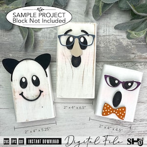 May include: Three white wooden blocks with distressed finishes, decorated as characters. One has black cat ears, one has grey glasses and a nose, and one has purple glasses and an orange polka dot bow tie. Text indicates dimensions 2" x 4" x 6.5".