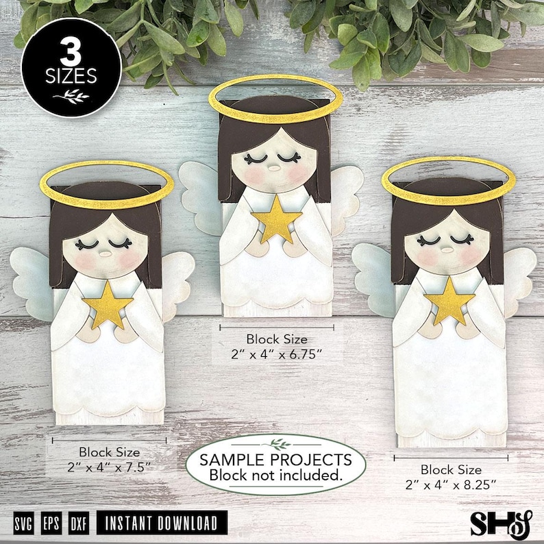 Op de afbeelding: Drie houten uitsparingen in de vorm van een engel met donkerbruin haar, witte gewaden en gouden halo's, elk met een gouden ster. Tekstlabels geven blokmaten aan van 5,08 cm bij 10,16 cm bij 17,15 cm, 19,05 cm en 20,96 cm.