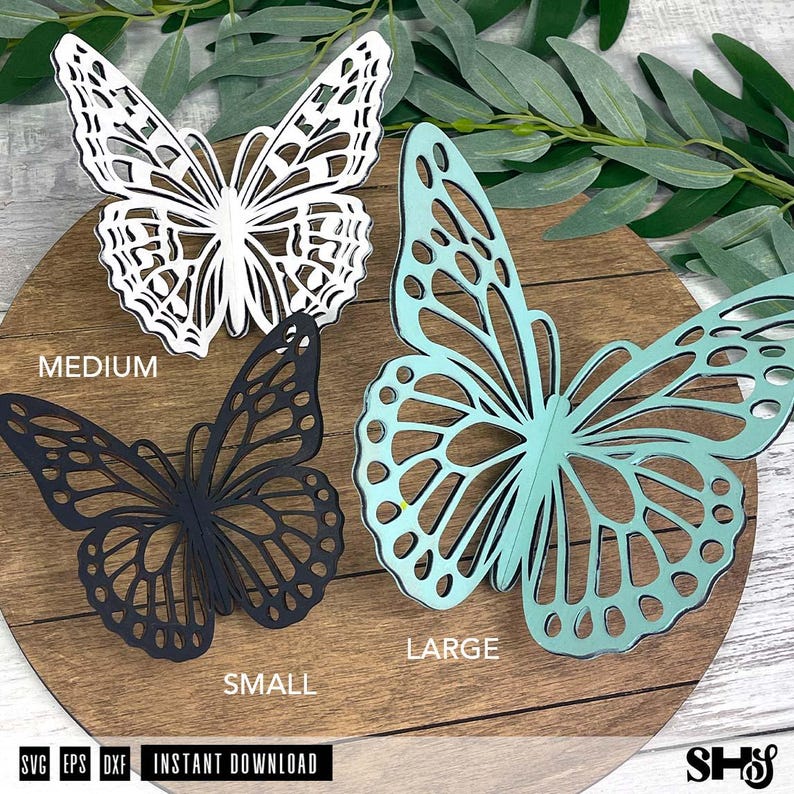 May include: Three die-cut butterfly shapes in white, black, and light teal. The white butterfly is labeled MEDIUM, the black butterfly is labeled SMALL, and the light teal butterfly is labeled LARGE. The text SVG, EPS, DXF, INSTANT DOWNLOAD is visible.
