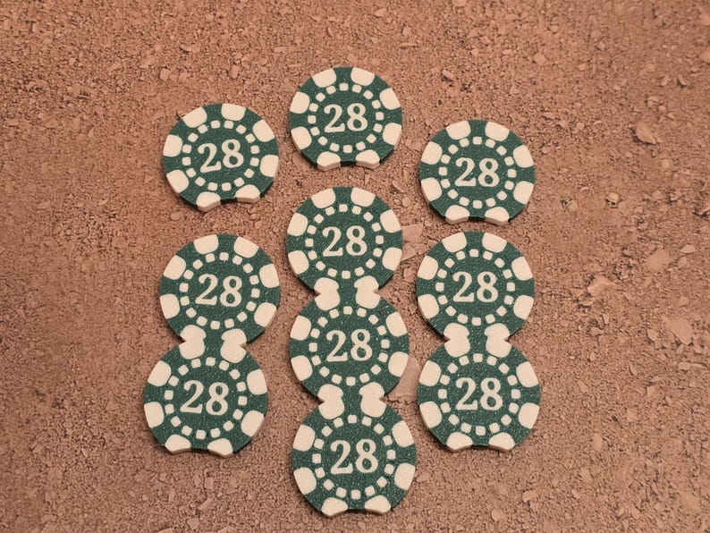 May include: Nine green and white poker chips with the number 28 printed on each chip.