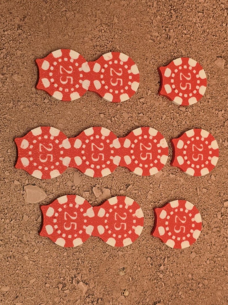 May include: Nine red poker chips with white lettering, each chip has the number "25" printed on it.