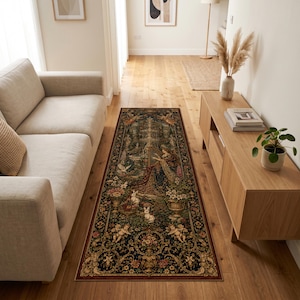 May include: A rectangular area rug featuring a dark, intricate design with a central fountain, floral motifs, cherubs, and white rabbits. The border is decorated with ornate gold and red patterns, creating a detailed tapestry-like appearance.