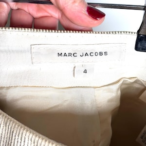 Inside waistband showing a Marc Jacobs brand label and a size 4 tag below it.