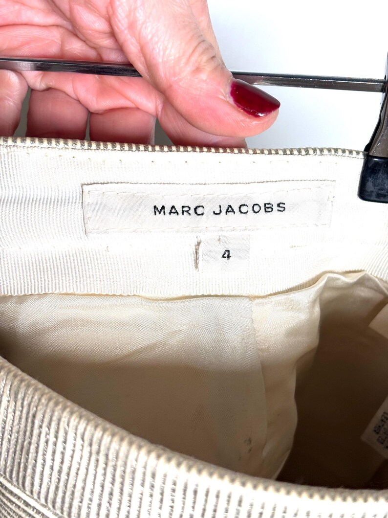Inside waistband showing a Marc Jacobs brand label and a size 4 tag below it.