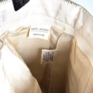 Interior lining showing the Marc Jacobs brand tag with style number W2310133 and a material tag.