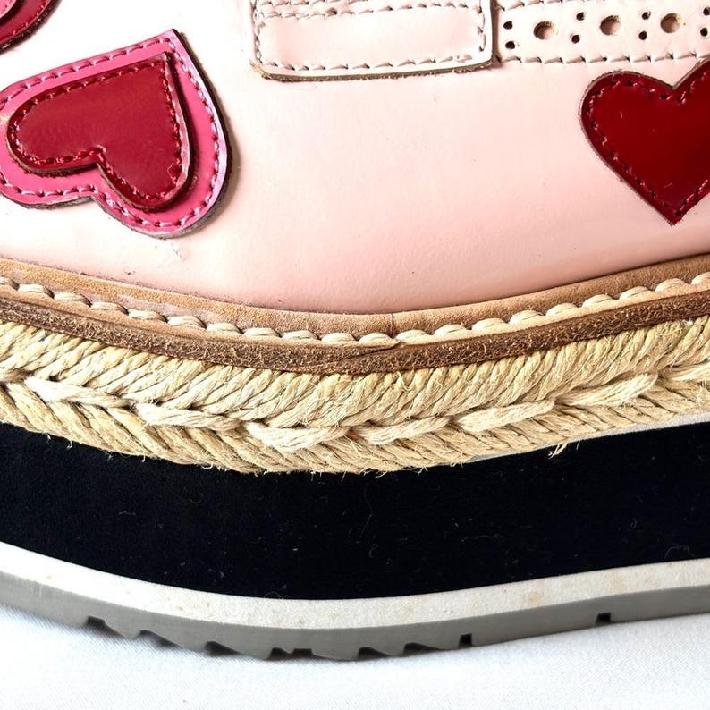 Close-up of the textured braided jute foxing band wrapping around the thick platform sole beneath the pink leather upper.