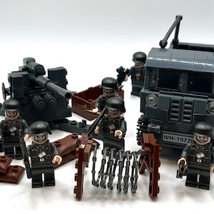 May include: A military-themed Lego set with a dark grey truck, artillery, soldiers, and barbed wire obstacles. The truck has the license plate "WH-19770". The soldiers are in black uniforms and helmets.