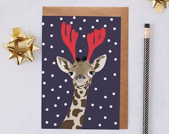 Giraffe Christmas card, Giraffe wearing antlers in the snow