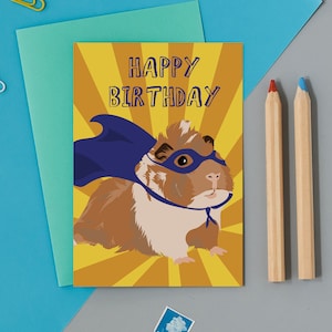 Joyeux anniversaire Treacle le cochon d’Inde super héros, cochon d’Inde au gingembre portant un masque et une cape.