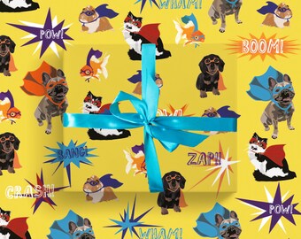 May include: Yellow wrapping paper with a repeating pattern of superhero animals, including dogs, cats, and fish, with speech bubbles saying "POW!", "BOOM!", "ZAP!!", and more. A turquoise ribbon and bow are tied around the wrapped gift.