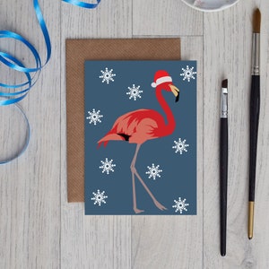 Carte de Noël Flamingo portant un chapeau de père Noël