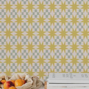 May include: A patterned wallpaper with a repeating design of yellow stars and checkered squares in a light green and white color scheme. A mesh bag filled with oranges and a stack of books are in the foreground.