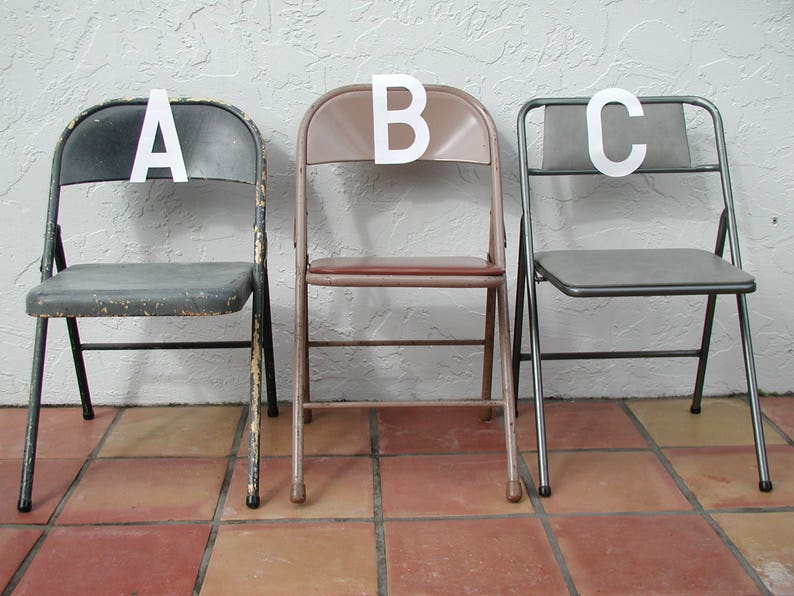 May include: Three metal folding chairs with black, gray, and brown seats. The chairs are labeled A, B, and C.