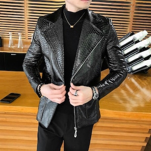 May include: A black leather jacket with a zip fastening and a snakeskin pattern. The jacket has a stand-up collar and long sleeves.