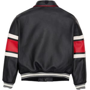 May include: Black leather jacket with red and white stripes on the sleeves. The jacket has a ribbed collar and cuffs with white stripes. A small emblem is visible on the back collar.