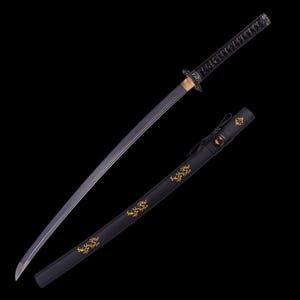 May include: A Japanese katana sword with a black handle and blade. The blade has a silver edge and is partially out of its black sheath. The sheath has gold decorative designs.