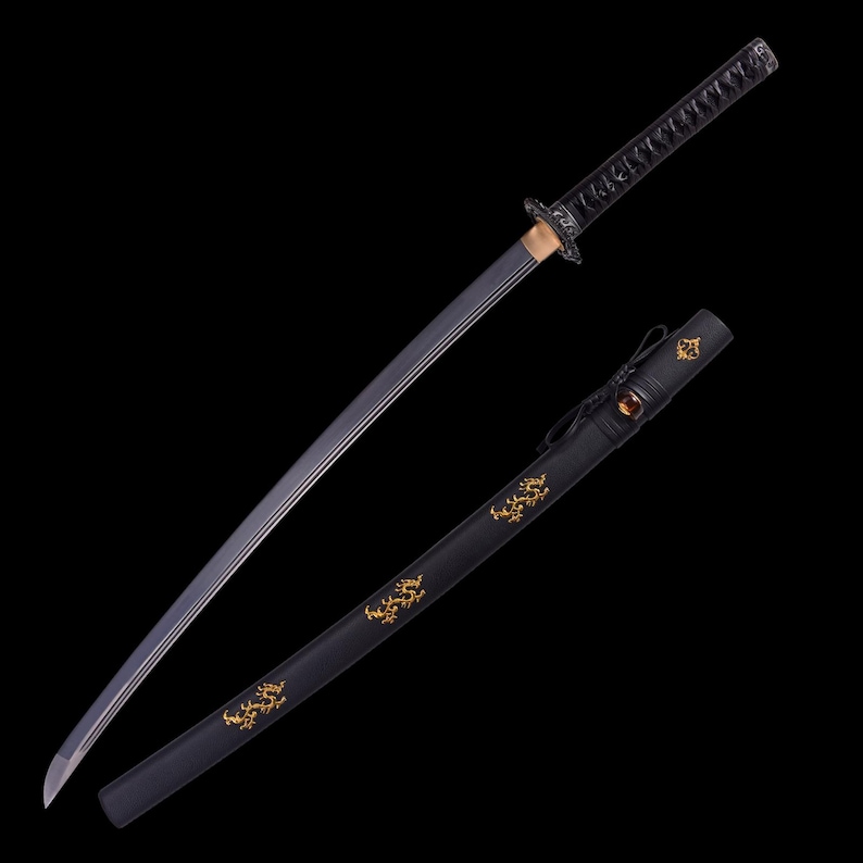 May include: A Japanese katana sword with a black handle and blade. The blade has a silver edge and is partially out of its black sheath. The sheath has gold decorative designs.