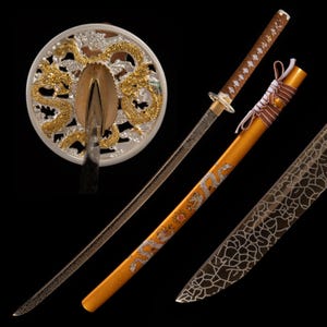 May include: A traditional Japanese katana sword with a gold and silver dragon design on the scabbard. The sword has a black blade and a brown handle. The sword is displayed on a black background.