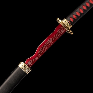 May include: A red and gold decorative sword with a black handle. The blade has a wavy design. The handle is wrapped in black material with red diamond-shaped accents. Gold accents are present on the hilt and scabbard.