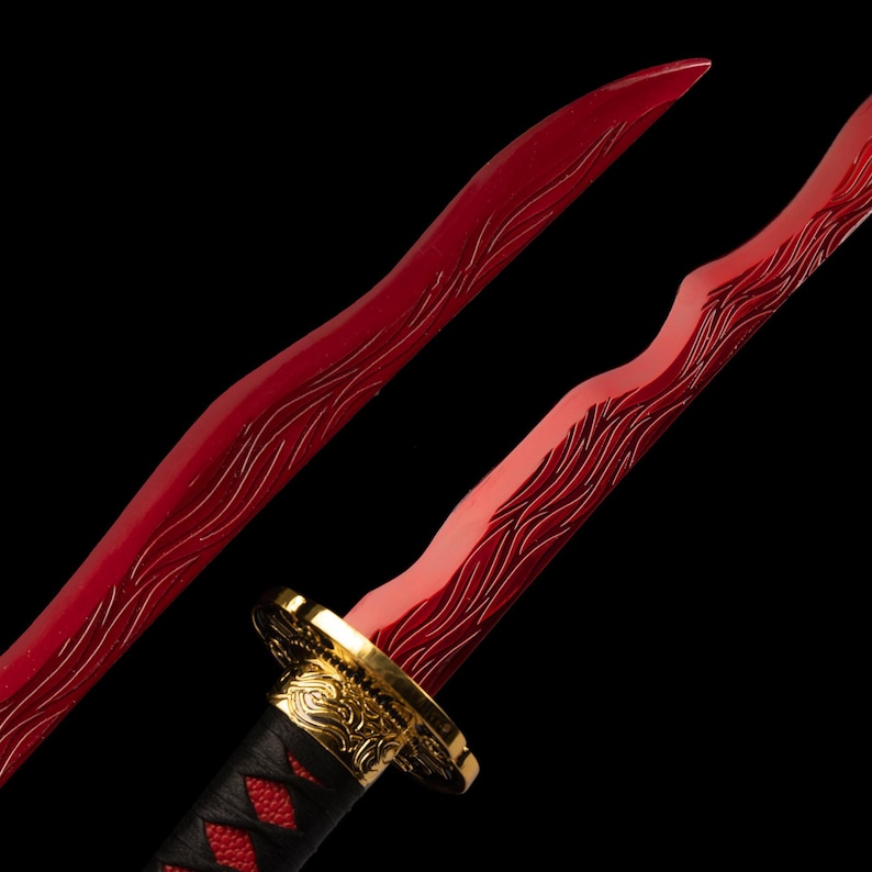May include: Close-up of a red katana blade with a gold hilt and black handle. The blade has a wavy design etched into the red surface. The handle is wrapped in black and red material.