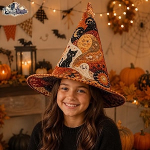 May include: A quilted witch hat featuring a vibrant orange and black pattern with illustrations of a black cat, a smiling moon, and a ghost. The fabric has a textured, stitched appearance with a pointed crown and a wide, slightly curved brim.
