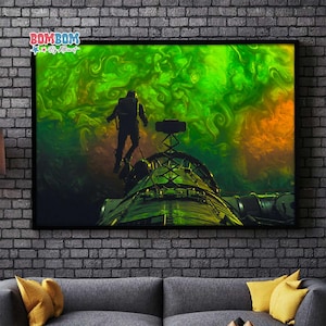 May include: A framed art print depicting an astronaut floating above a futuristic structure against a swirling green and orange nebula. The artwork has a dark, sci-fi theme, with the text "BOM BOM By Athwart" in the upper left corner.