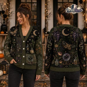 May include: A black and olive green button-up cardigan featuring a detailed knit pattern of moths, snakes, crystal balls, potion bottles, crescent moons, spiderwebs, and various botanical elements. The design is displayed on both the front and back.