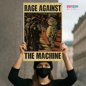 May include: A poster with the words "RAGE AGAINST THE MACHINE" in bold black letters. The poster features a cartoon frog facing police officers. The frog is wearing a scarf and has spots. The background shows a crowd of people.