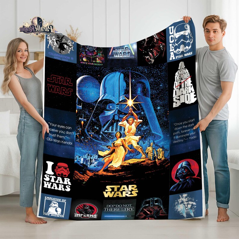 May include: A Star Wars-themed blanket featuring Darth Vader, Luke Skywalker, and other characters. The design includes the Star Wars logo and various quotes. The blanket is primarily blue and black with white text.