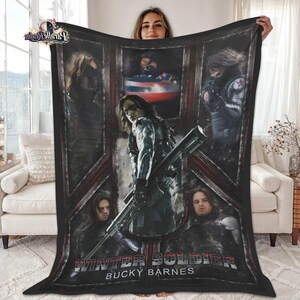 May include: A black blanket featuring multiple images of the Winter Soldier, with the text "Winter Soldier Bucky Barnes" in white. The blanket has a dark red and gray geometric design.