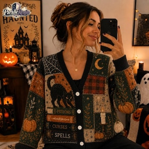 May include: A long-sleeve button-down cardigan featuring a patchwork design with a black cat, stacked books labeled Potions, Curses, and Spells, pumpkins, a crescent moon, and spiderwebs in shades of dark green, orange, and black.