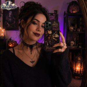 May include: A black smartphone case featuring a graphic illustration of a cat wearing a crown and cape riding a dinosaur. The text reads Princess Donut & Mongo and Halloween Crawl. The case has a dark background with moon and star accents.