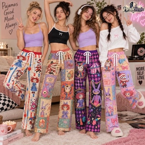 May include: Four individuals wearing crop tops and patterned pajama pants featuring circus-themed illustrations, including clowns, rabbits, and 'Admit One' tickets. The pants have elastic waistbands with white drawstrings and colorful patchwork designs.