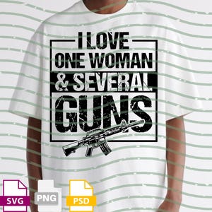 May include: White t-shirt with a black graphic design. The design includes the text "I LOVE ONE WOMAN & SEVERAL GUNS" in a bold, blocky font, along with an illustration of a rifle. The shirt also has SVG, PNG, and PSD file icons.