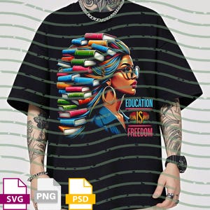 Op de afbeelding: Zwart t-shirt met een kleurrijke illustratie van een vrouw met boeken in haar haar, een bril en gouden oorringen. De tekst "EDUCATION IS FREEDOM" staat eronder.