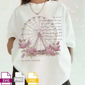 May include: Cream-coloured sweatshirt with a Ferris wheel design, lilac flowers, and script text. The text includes the phrase "THE ELDEST DAUGHTER". The design is in shades of brown, purple, and green.