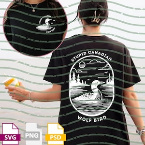 May include: Black t-shirt with a white graphic of a loon on water, surrounded by trees and the text "STUPID CANADIAN WOLF BIRD". The shirt also has a smaller graphic on the front. The shirt is a casual wear item.