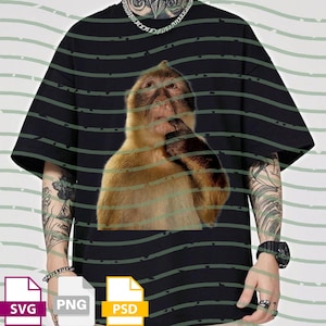 May include: Black t-shirt featuring a large, detailed image of a monkey in a thoughtful pose. The monkey has brown fur and is touching its chin. The shirt has a crew neck and short sleeves. The background has green horizontal stripes.