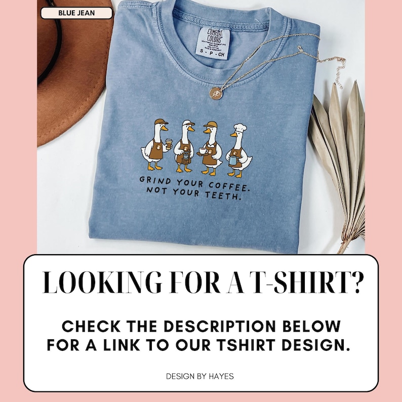 May include: Pale blue t-shirt featuring a cartoon design of four geese serving coffee, with the text "GRIND YOUR COFFEE. NOT YOUR TEETH." The shirt also has the text "LOOKING FOR A T-SHIRT? CHECK THE DESCRIPTION BELOW FOR A LINK TO OUR TSHIRT DESIGN."